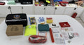 Actual EK124 roadside emergency kit and included contents displayed together